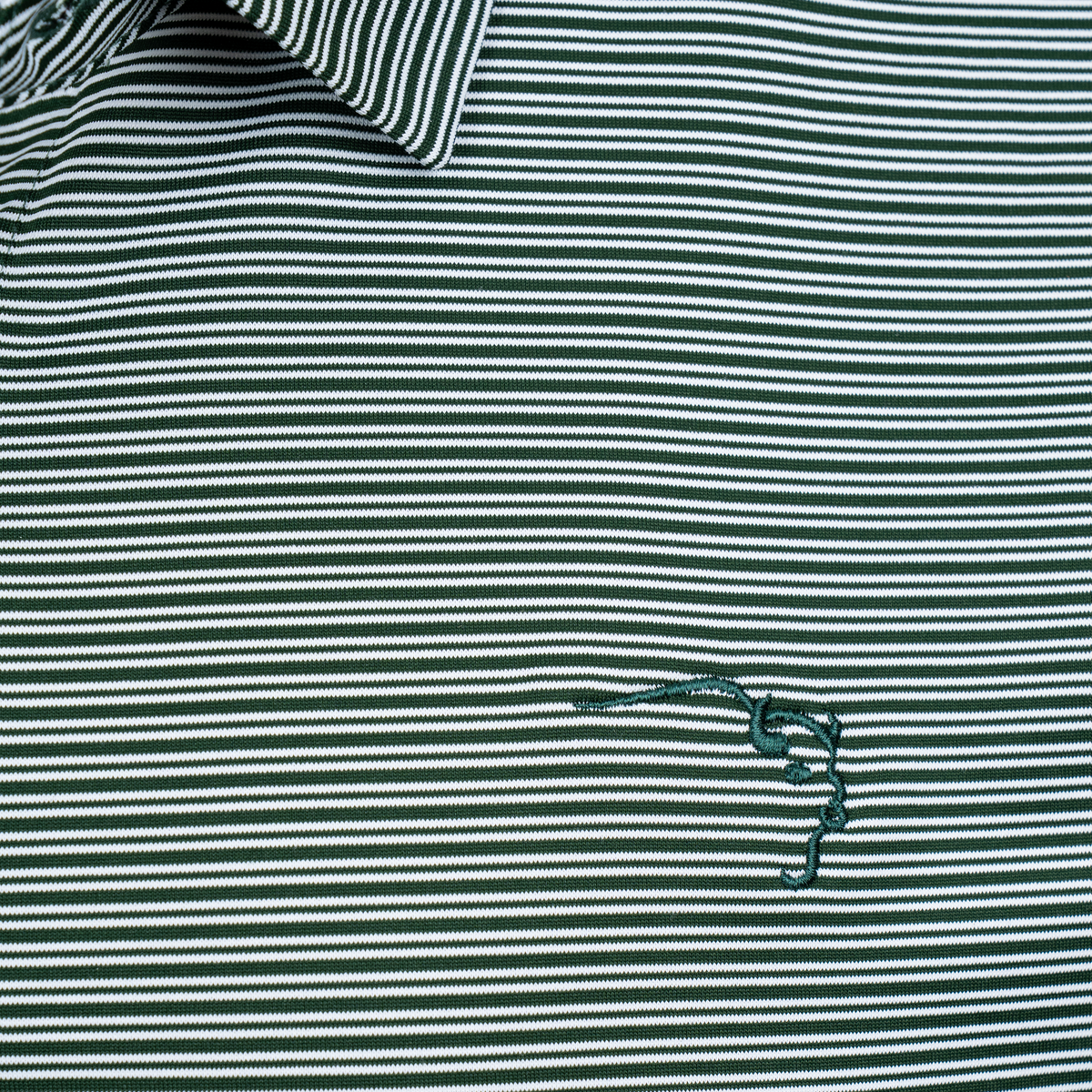 Buffalo Trace Cutter & Buck Striped Polo close-up of stripe pattern and embroidered chest logo