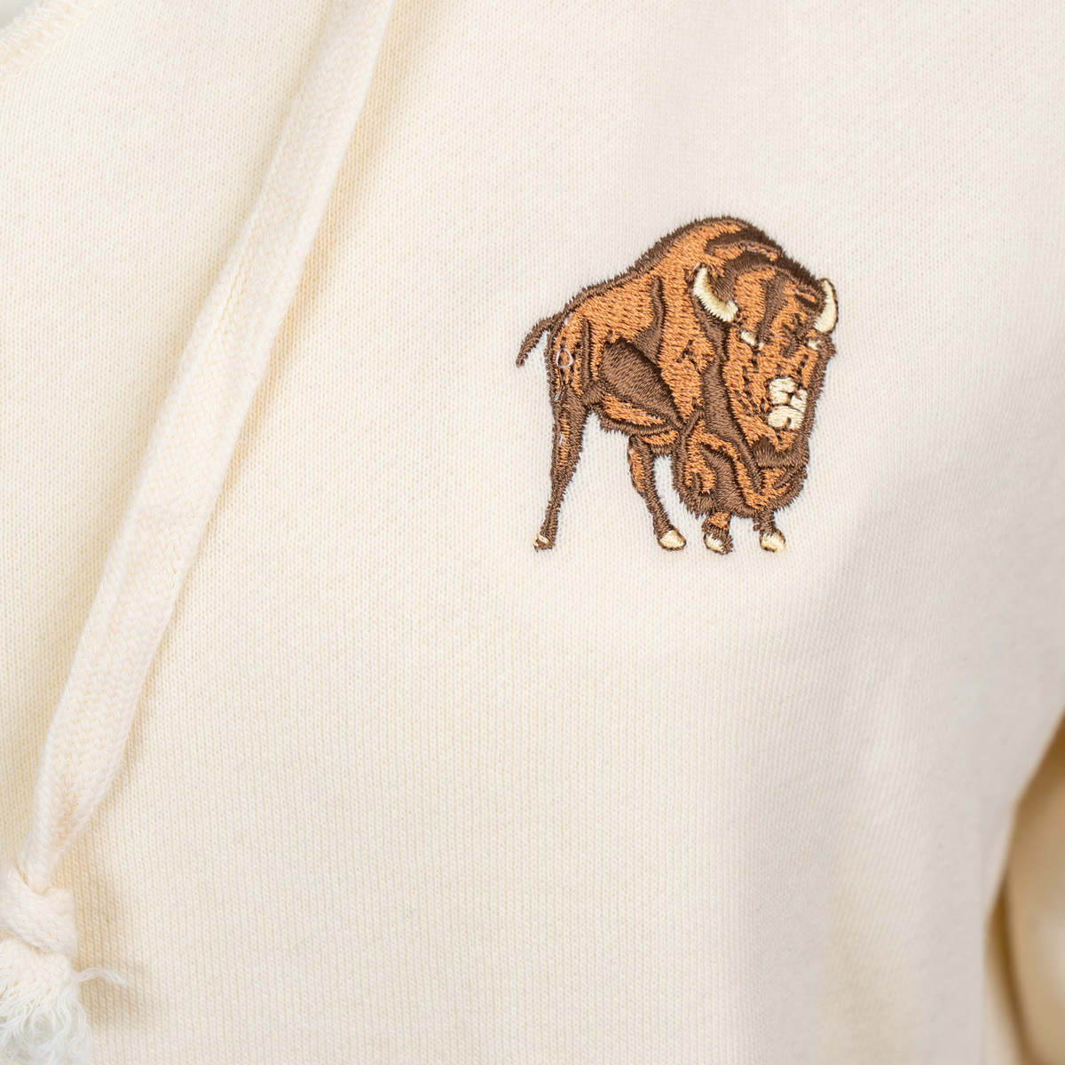 Buffalo Trace Women's Cream Hoodie close-up of embroidered Buffalo Trace logo on chest