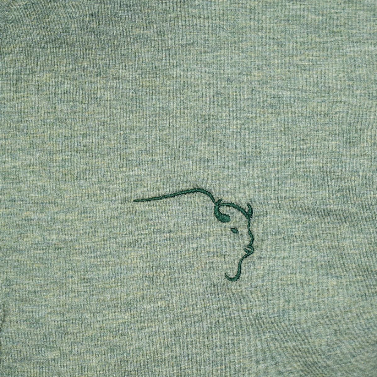 Buffalo Trace Green Heather Everywhere Swoosh Polo close-up of heather fabric and swoosh pattern detail