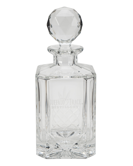 Clear glass Buffalo Trace decanter with a spherical stopper on a white background