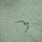 Buffalo Trace Green Heather Everywhere Swoosh Polo close-up of heather fabric and swoosh pattern detail
