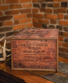 George T. Stagg wooden box with text against a brick wall